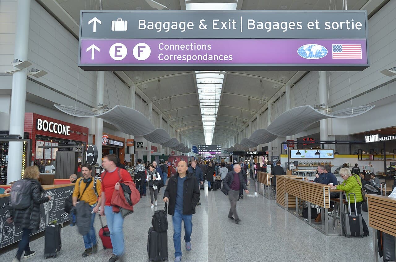 Travelers moving through Terminal 1 at Toronto Pearson International Airport.